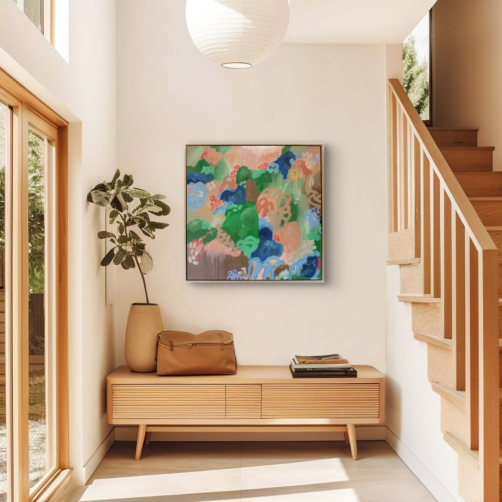 Modern interior with a colorful abstract painting, wooden bench, and staircase.